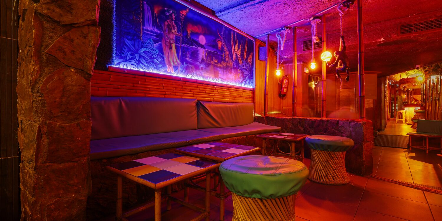 Tiki corner decorated with masks and bamboo