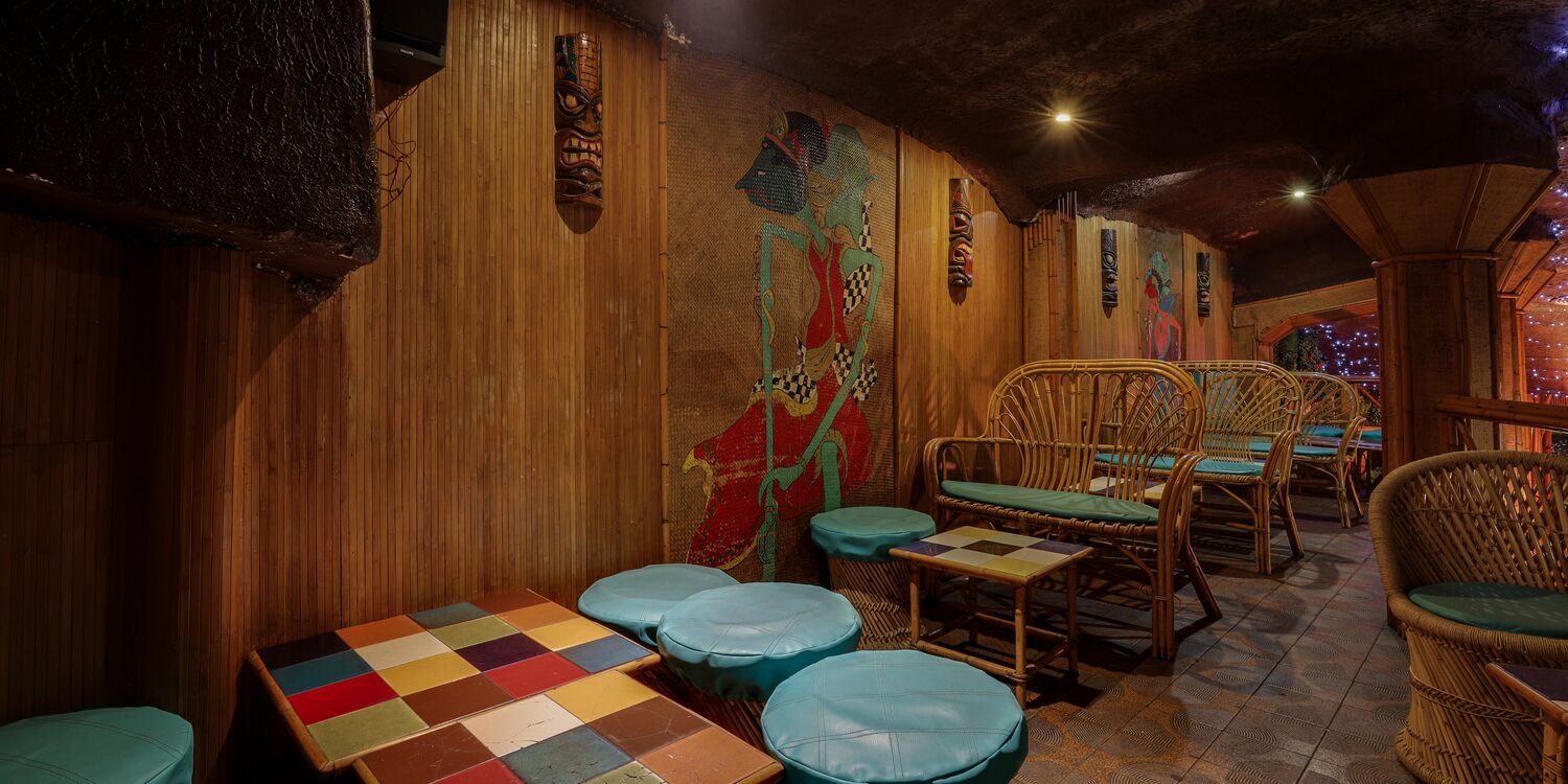 Hand-painted tiki mural next to the lounge area