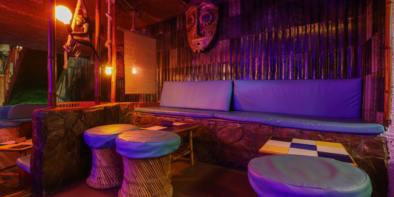 Purple-toned booth seating at Kahiki Barcelona
